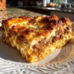 A close-up of a hearty slice of Lasagna with Cottage Cheese, showing layers of pasta, meat sauce, and creamy cheese.