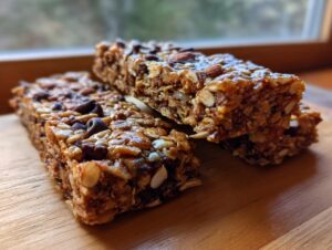Close-up of no bake trail mix bars packed with oats, nuts, seeds, and chocolate chips.