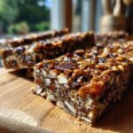 Close-up of delicious no bake trail mix bars packed with oats, nuts, and dried fruit on a wooden board.