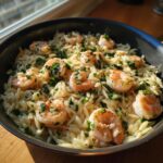 Close-up of shrimp orzo in a lemon garlic sauce, garnished with fresh parsley.