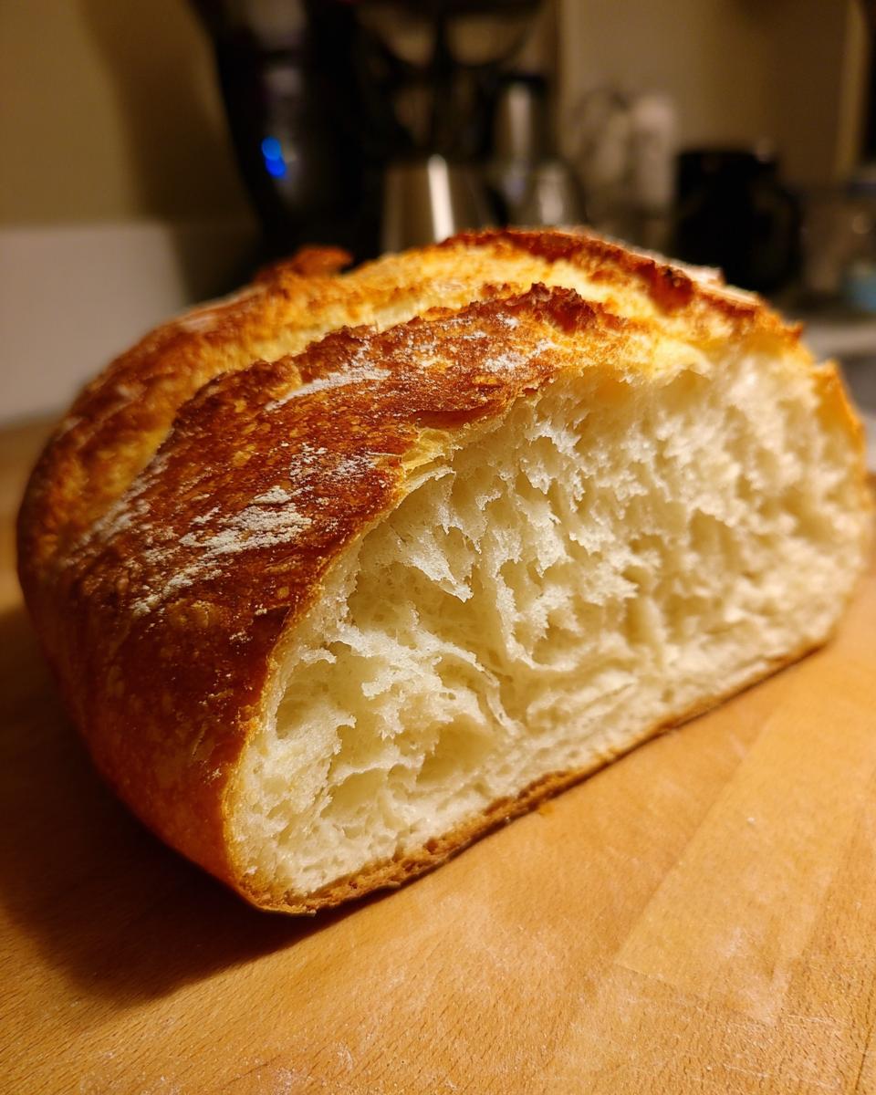 A close-up of a slice of zero carb yogurt bread, showcasing its fluffy interior and golden-brown crust.