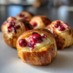 Close-up of delicious Cranberry Cream Cheese Crescent Bites filled with cream cheese and topped with cranberries.