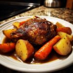 A single serving of glazed braised chicken thighs surrounded by roasted carrots and potatoes in rich brown sauce.