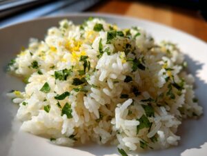 Close-up of fluffy cilantro lime rice garnished with chopped cilantro and bright yellow lime zest.