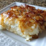 Close-up of a square serving of creamy french onion butter rice topped with crispy caramelized onions.