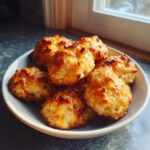 A small bowl filled with golden brown, baked 3 ingredient sausage balls, perfectly browned on top.