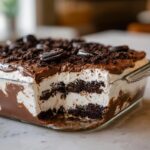 A cross-section view of the Baileys Chocolate Cheesecake Trifle showing layers of cream, chocolate, and cookie crust.
