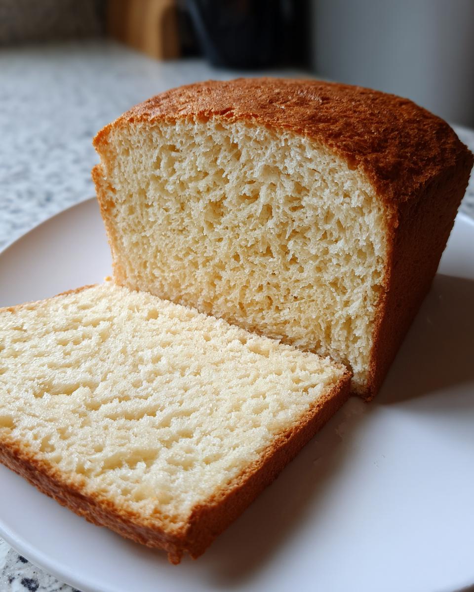 Close-up of a loaf of amazing 1-hour gluten free bread, showing a soft, even crumb texture and golden crust.