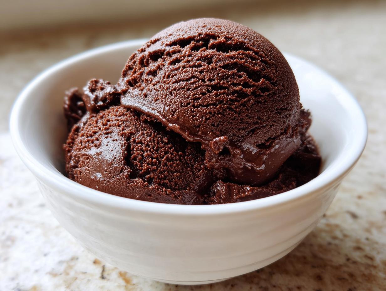 Two generous scoops of rich, dark No churn chocolate ice cream served in a small white bowl.